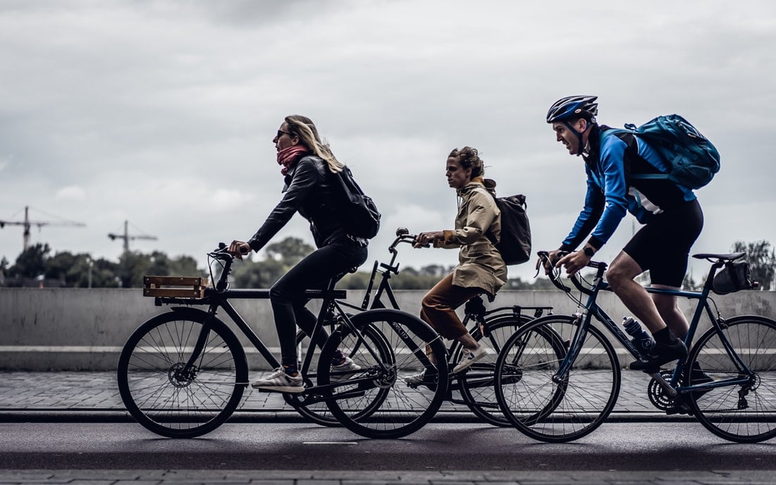 Three cyclists commute