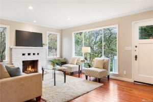 Living room with windows and fireplace in the craftsman Broadview home