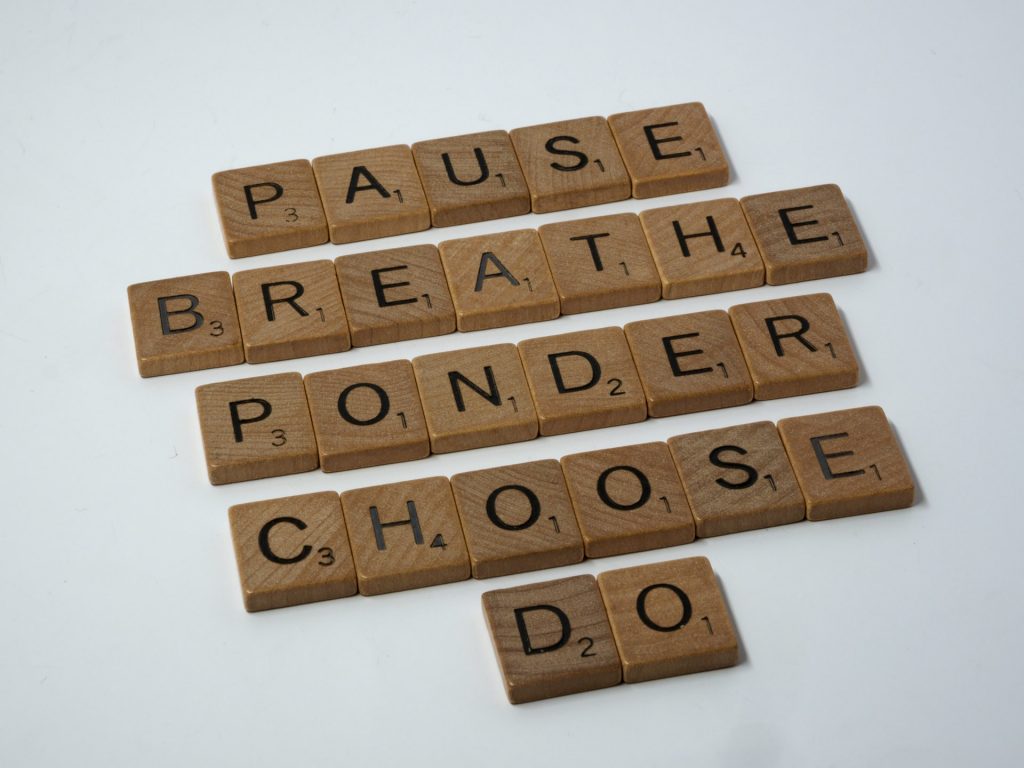 Letter tiles spelling the words "pause," "breathe," "ponder," "choose", and "do"