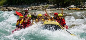Eight people are in a raft going down a river