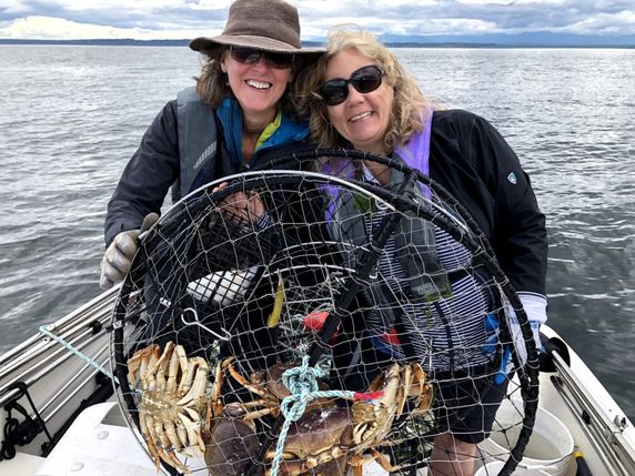 Jayn and her wife Karen on a boat crabbing
