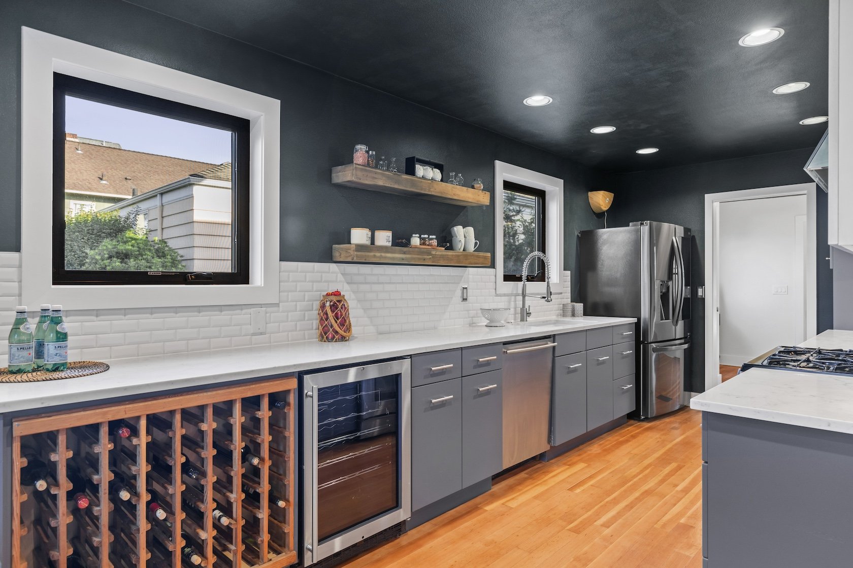 The kitchen at 116 NE 58th St has stainless steel appliances, a wine refrigerator and other elegant touches