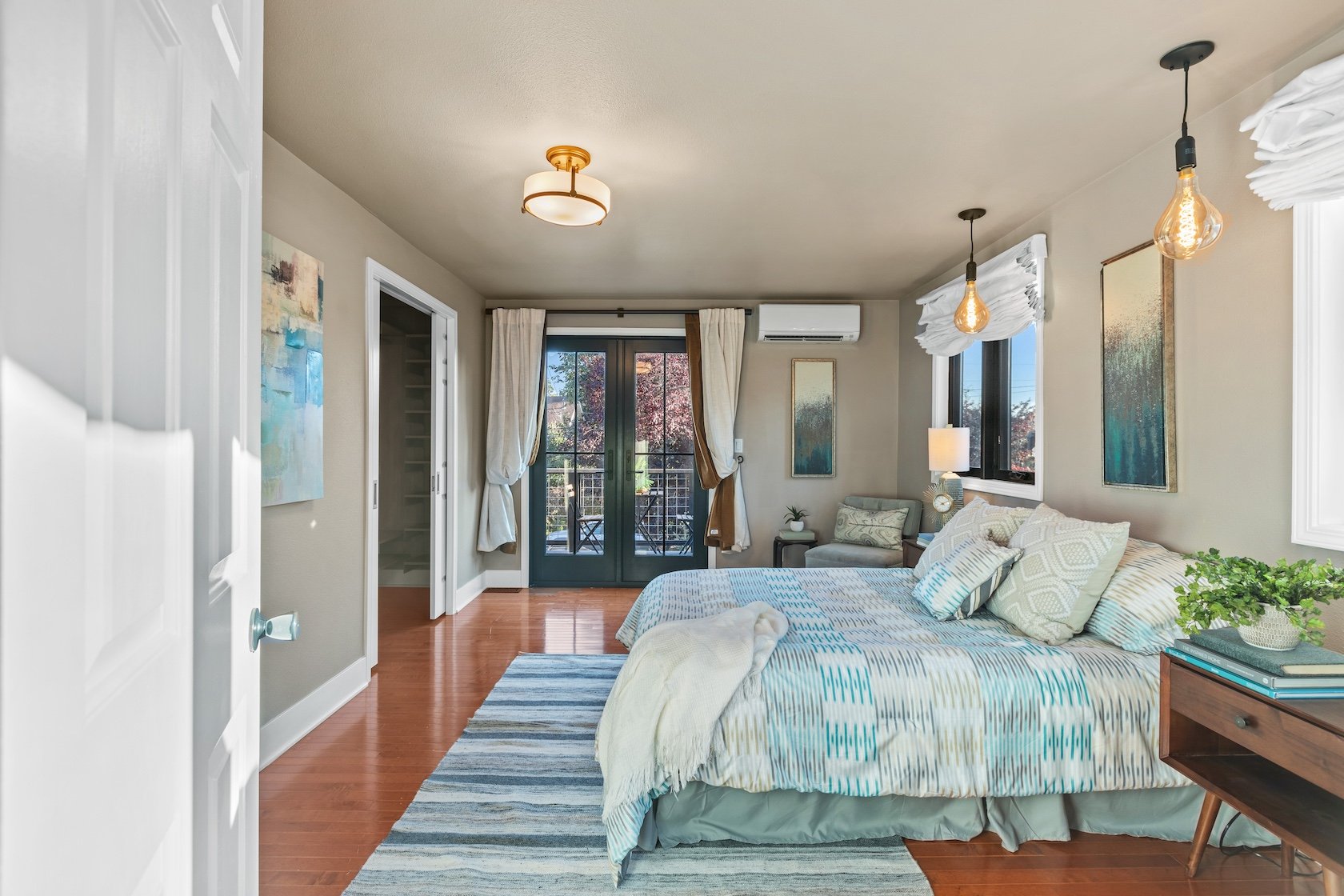 Sumptuous living in the primary bedroom of 116 NE 58th St