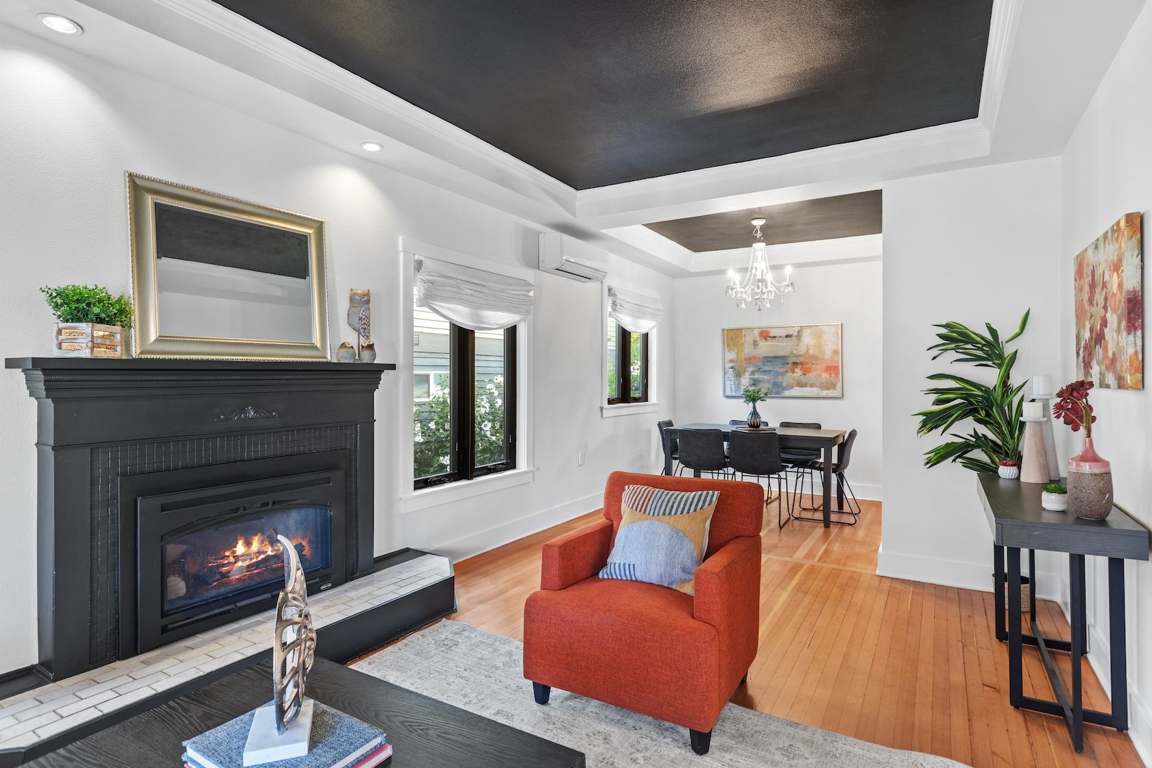 The living room at 116 NE 58th St has classic touches, including shining flooring and a fireplace insert