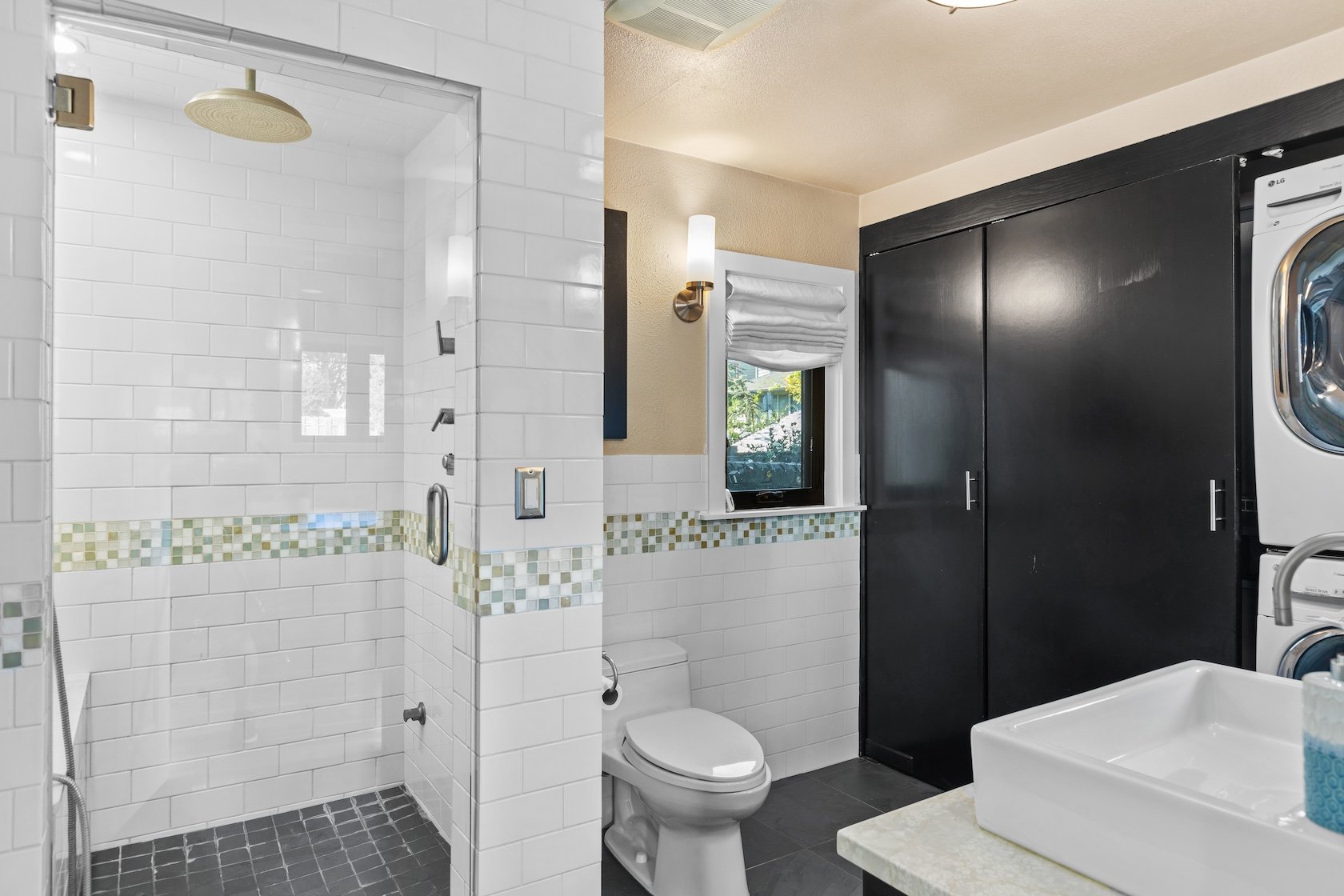 This bathroom at 116 NE 58th St has a rain shower and other elegant touches