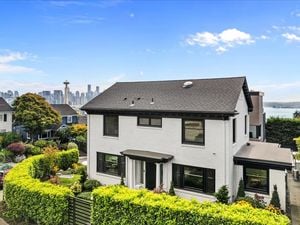 The Exterior of this Colonial Home at 503 W Prospect St, Seattle, WA 98119 has the Space Needle and downtown Seattle in the background