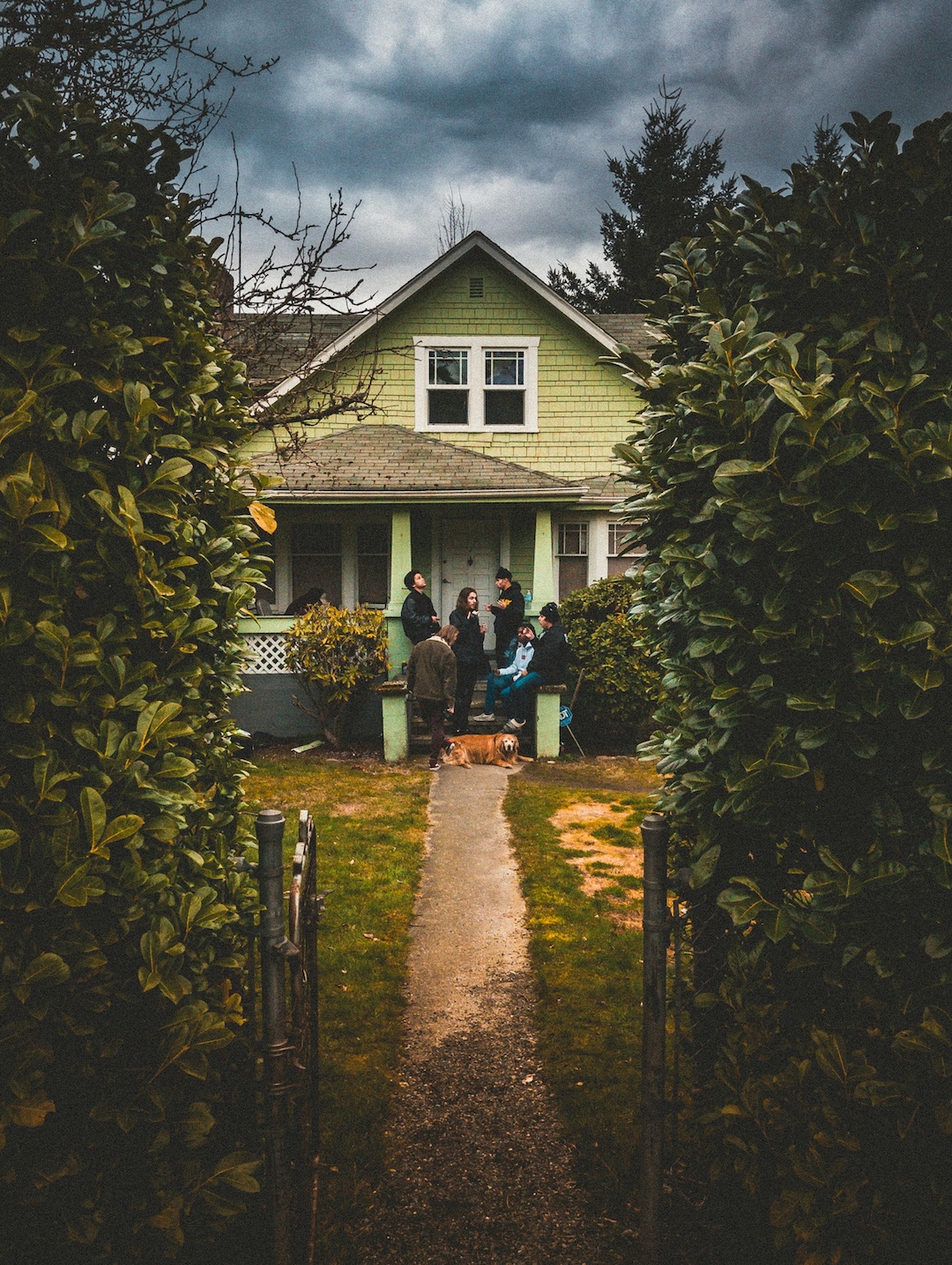 Friends smoking outside of a green house