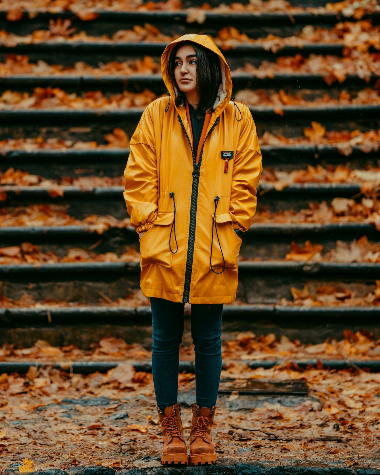 A woman wearing a rain jacket in autumn