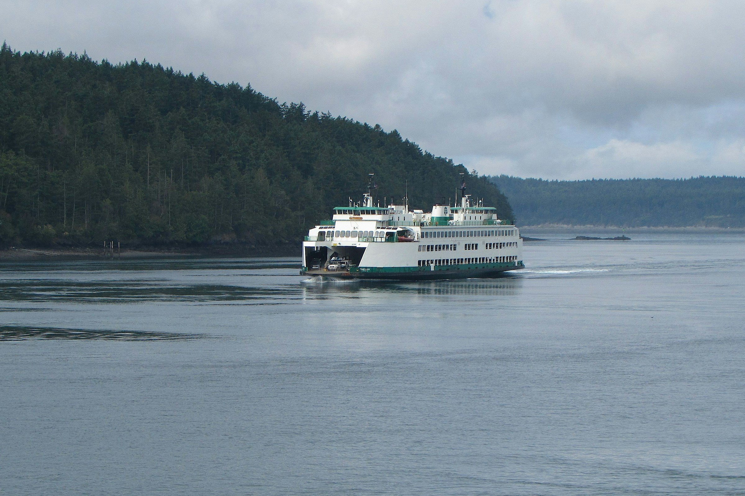 A ferry loaded with cars and walk-on passengers crosses Puget Sound