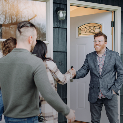 Agent welcoming home buyers to home tour
