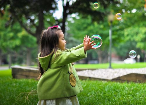 Girl catching bubble