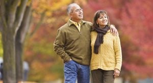 Hispanic couple walking outdoors in autumn