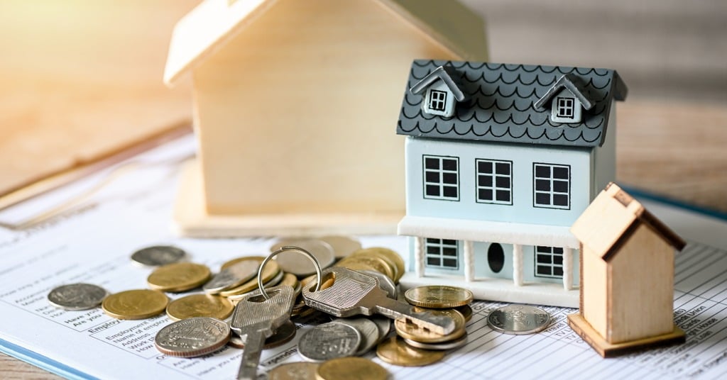 Tax form with house key on top, symbolizing capital gains tax rules for homeowners selling property in Kirkland.