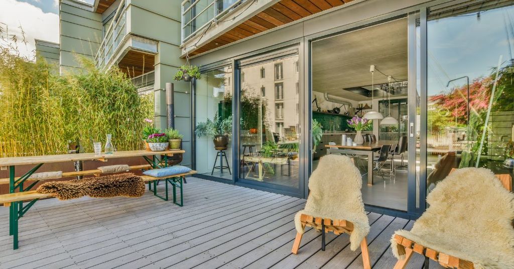 Luxury indoor-outdoor living space with retractable glass doors and patio seating