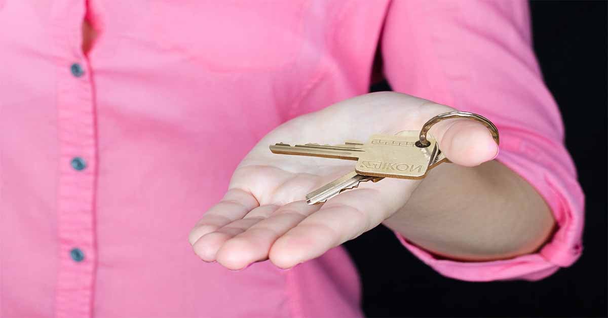 Real Estate Professional holding the keys to a house.