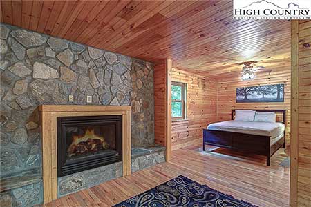 Bedroom with fireplace in 175 Payton Lane a Banner Elk, NC home