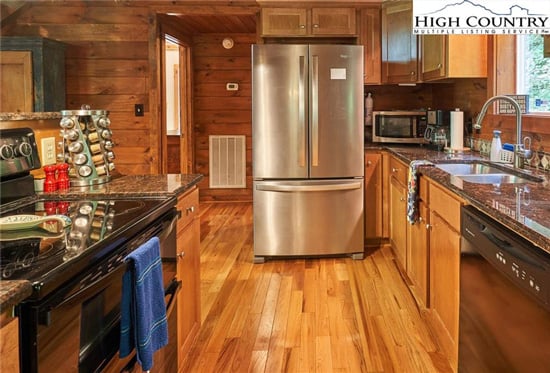Kitchen inside log cabin home.