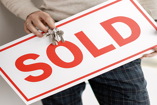 Buyer or selling selling their home after a successful real estate closing day.