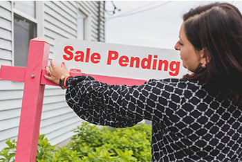 Boone real estate agent putting out a home sale pending sign
