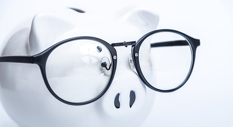 Piggy bank with glasses. Educational costs concept.