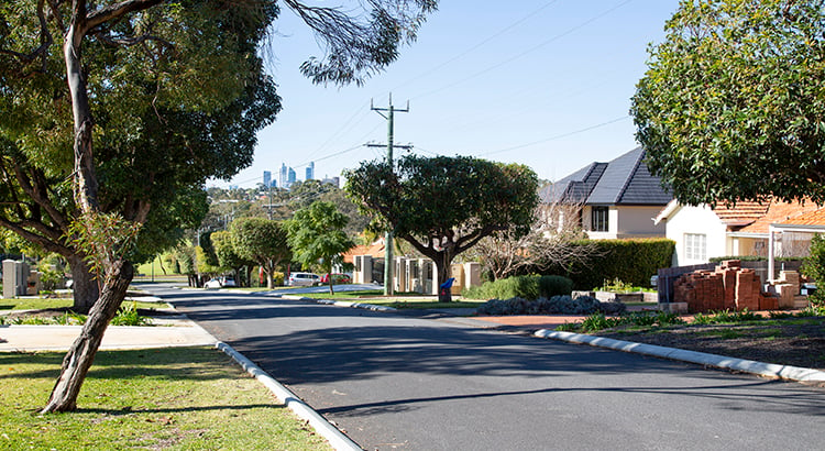 Suburban street with city in background