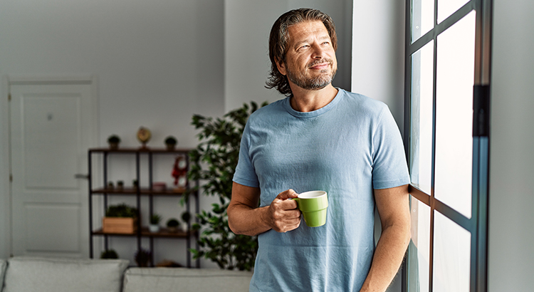 Man smiling confident drinking coffee at home