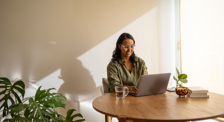 Young woman working from home with a laptop