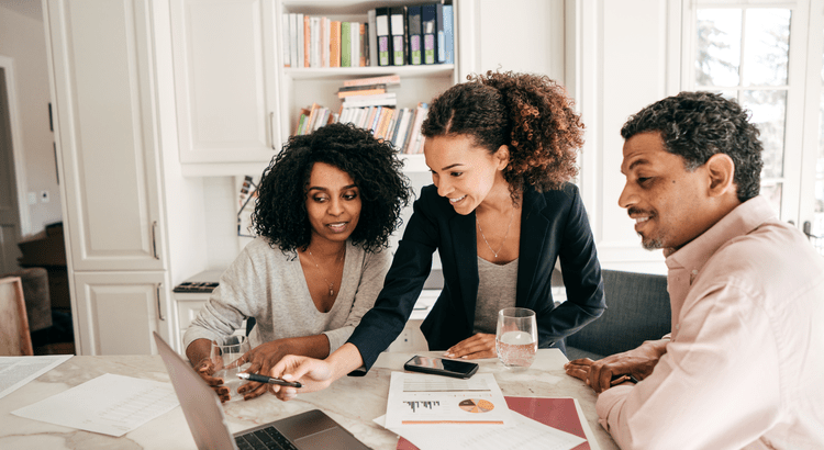 Agent reviewing a contract with a home selling couple