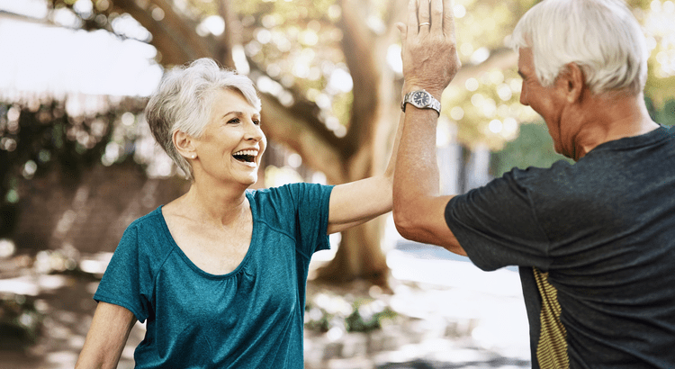 An older couple high-fiving