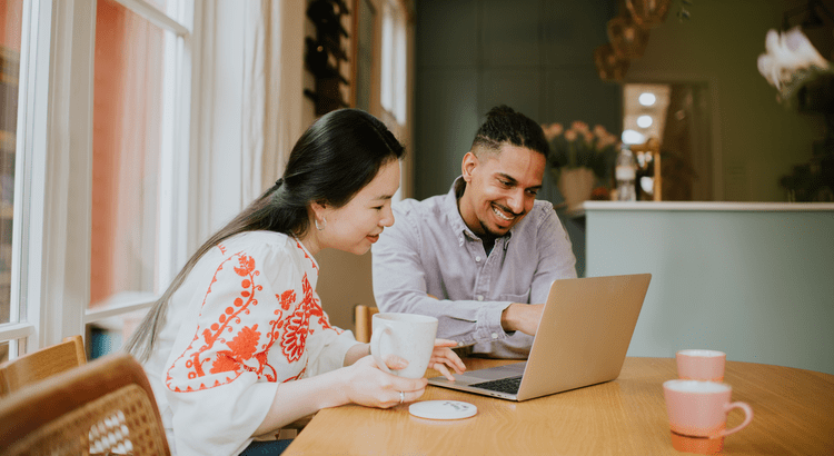 A couple reviewing their finances at the kitchen table.