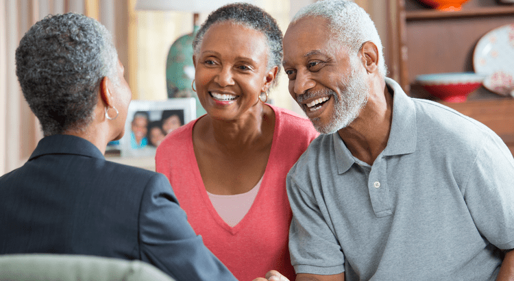 An older couple smiling with their real estate agent