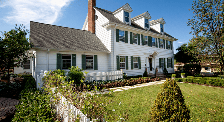 Colonial suburban home with a picket fence