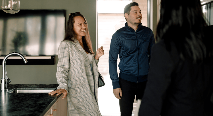 A couple and their real estate agent touring homes