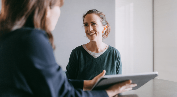Real estate agent and homeowner reviewing housing market data together