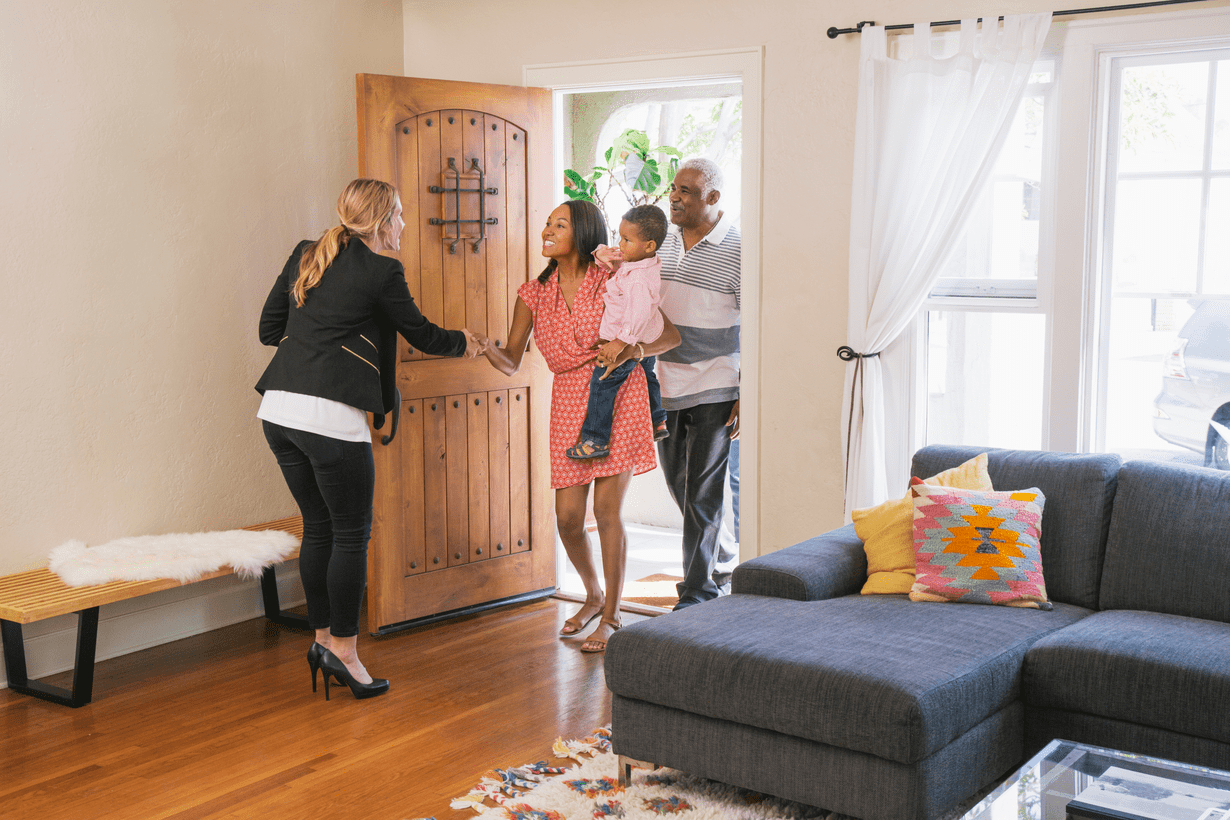 A young family meeting with an agent to tour a home for sale