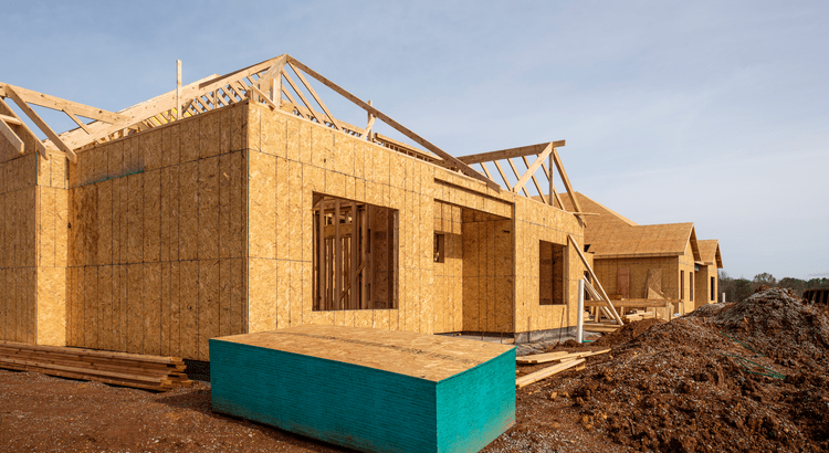 A new construction home with plywood siding