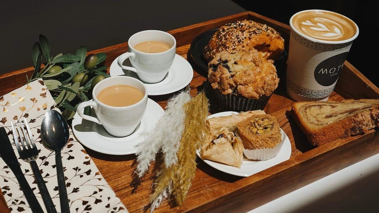 Chai, a latte and pastries on a wooden tray at MOTW Coffee and Pastries in Reston
