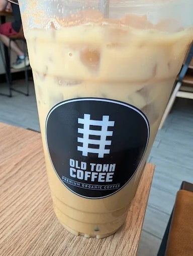 Iced latte in an Old Town Coffee cup in Herndon