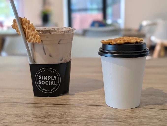 Iced and hot drinks topped with waffle cookies at Simply Social Coffee on Sunrise Valley Drive in Reston