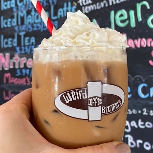 Iced coffee with whipped cream in a Weird Brothers Coffee cup in Herndon