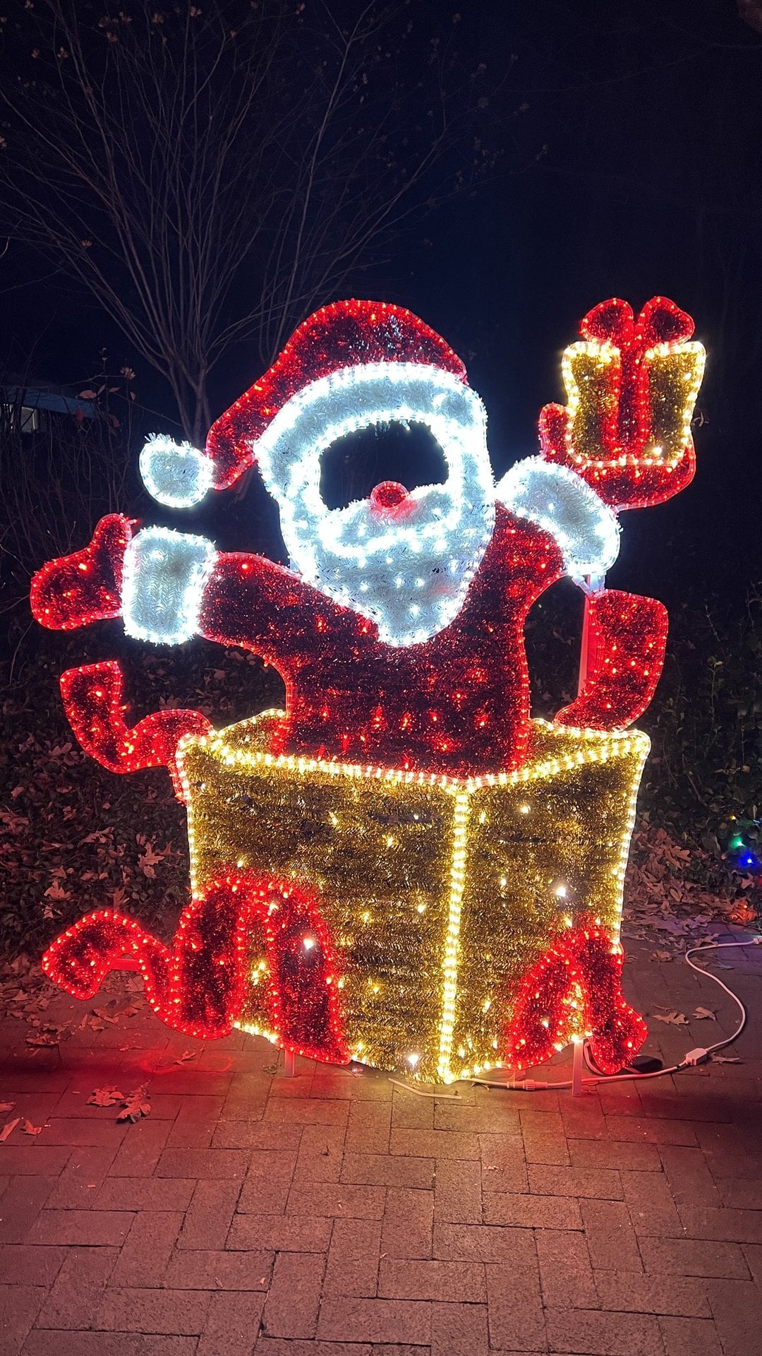 Lighted display of Santa bursting out of a gift box at Winterfest in Reston, Virginia