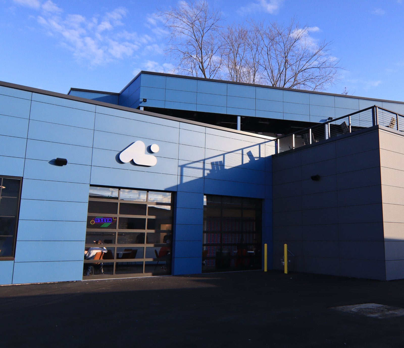 Aslin Beer Company taproom on Elden Street in downtown Herndon, with its blue exterior and rooftop deck