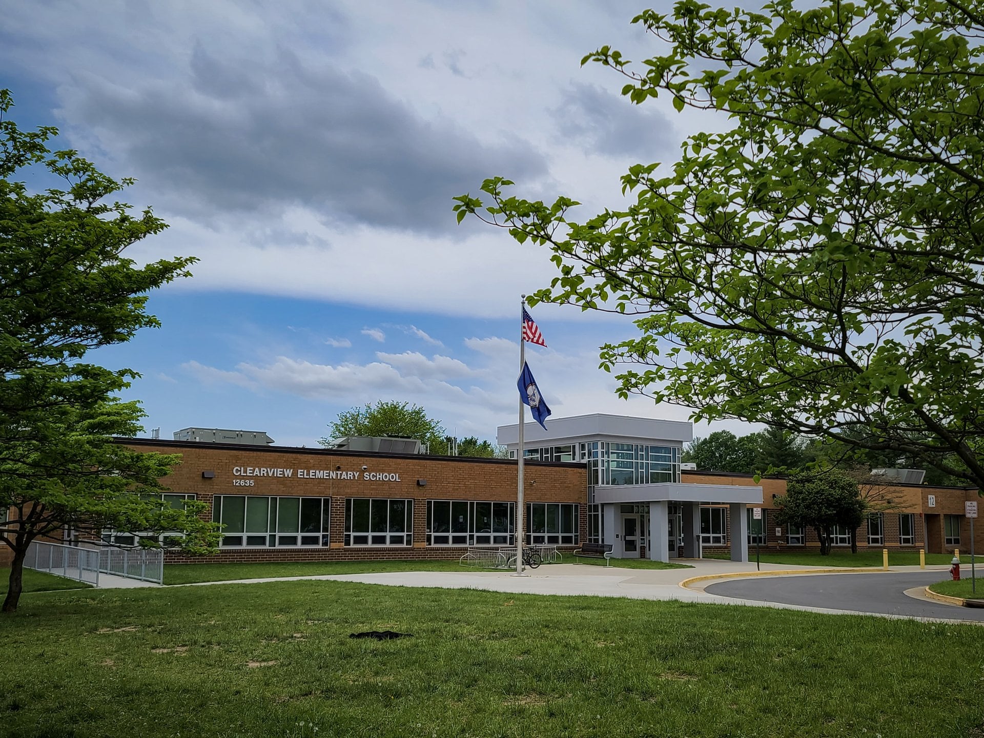 Front of Clearview Elementary School on Builders Road in Herndon, Virginia, with the flagpole and glass entrance added in the 2021 renovation