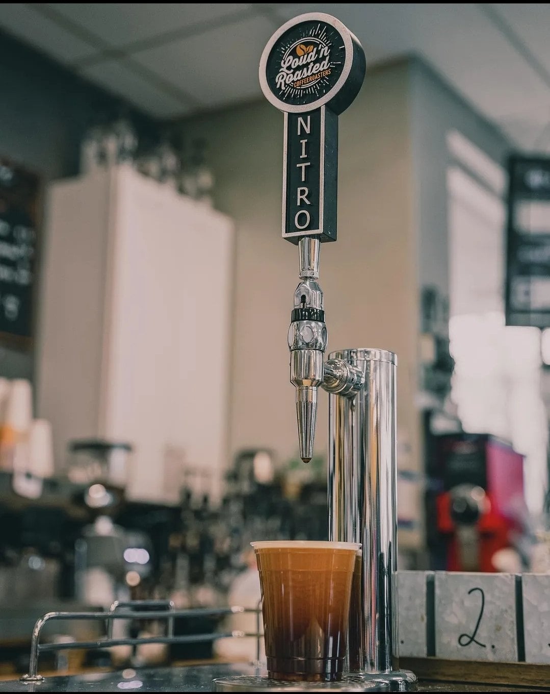 Nitro cold brew pouring from a tap at a Loud'n Roasted coffee bar