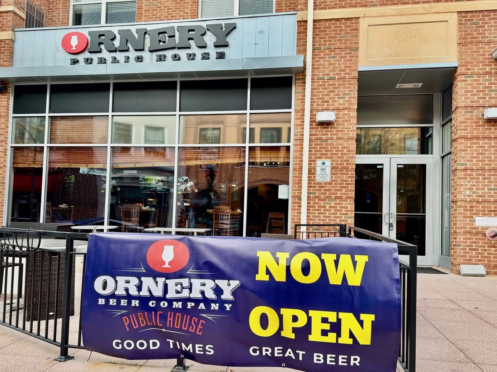 Ornery Beer Company Public House storefront in Woodland Park Crossing, Herndon, with a Now Open banner