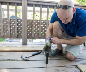 man repairing wood deck, nashville tn