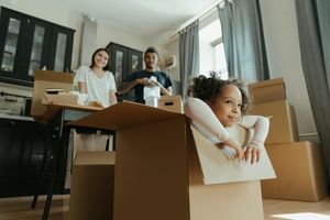 Little girl playing in moving box
