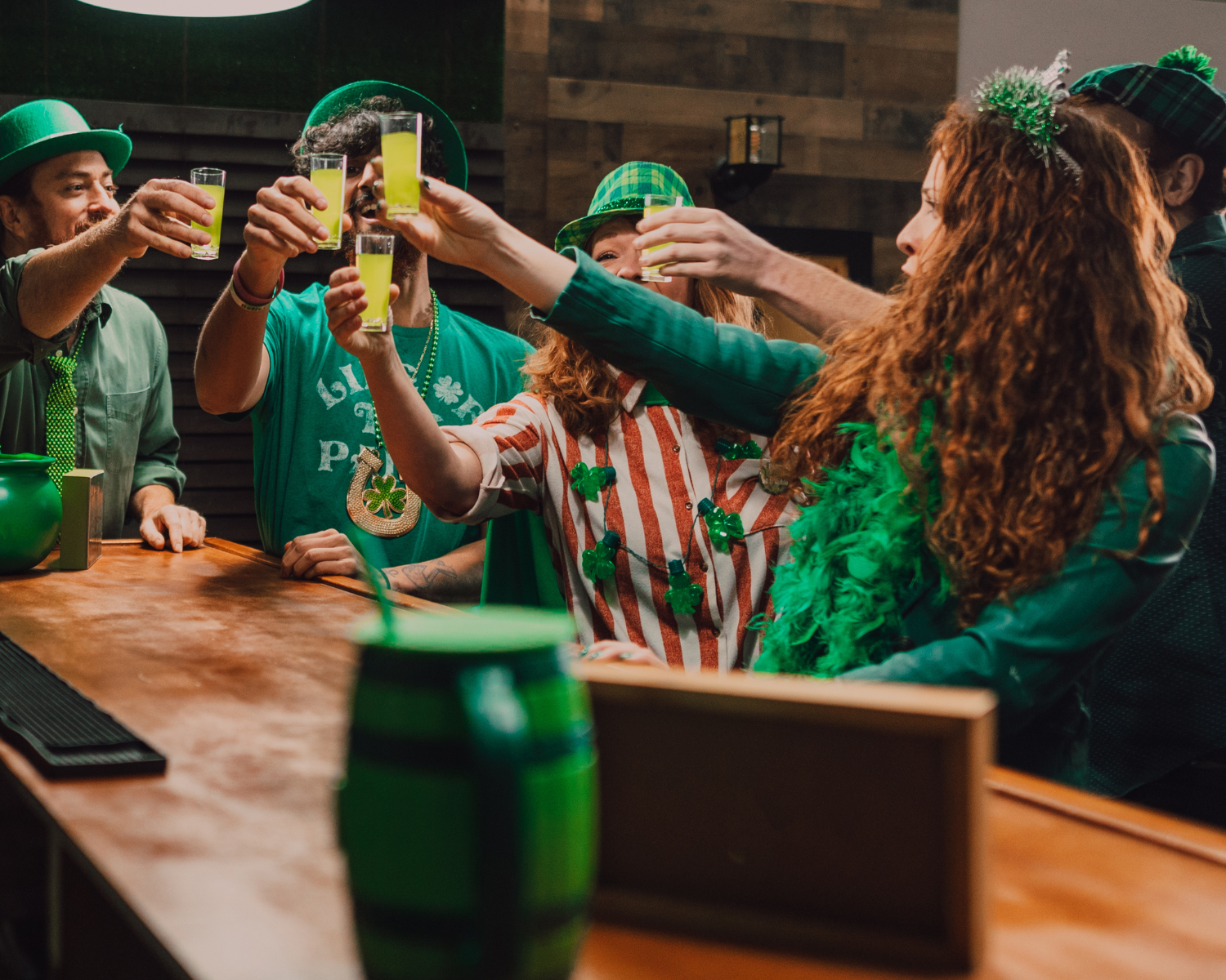 People celebrating St. Patrick’s Day in Roswell, GA at a bar crawl, enjoying drinks and music.