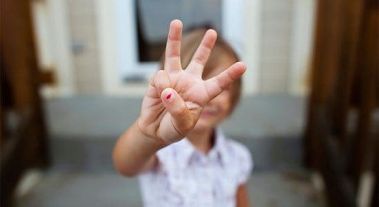 Kid showing 3 fingers