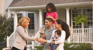 Couple with their kids doing shake hands with real estate professional